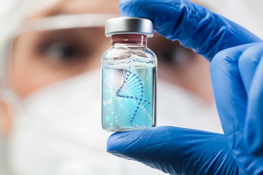 Uk,lab,scientist,biotechnologist,holding,glass,ampoule,phial,with,dna